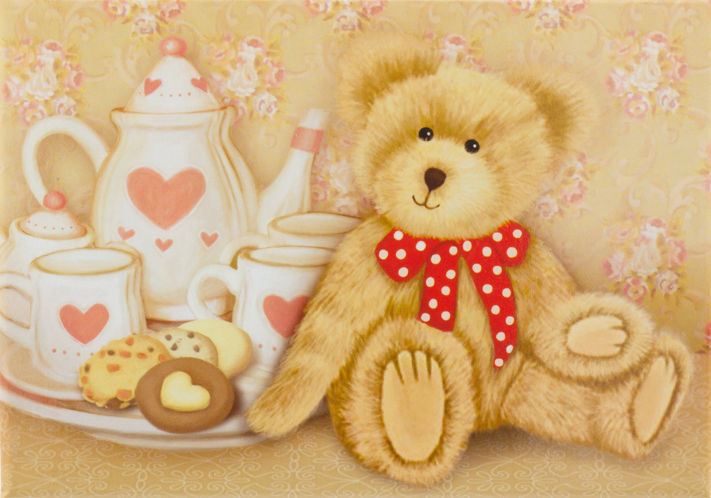 Teddy bear with a red polka dot bow tie sitting next to a tea set on a floral background